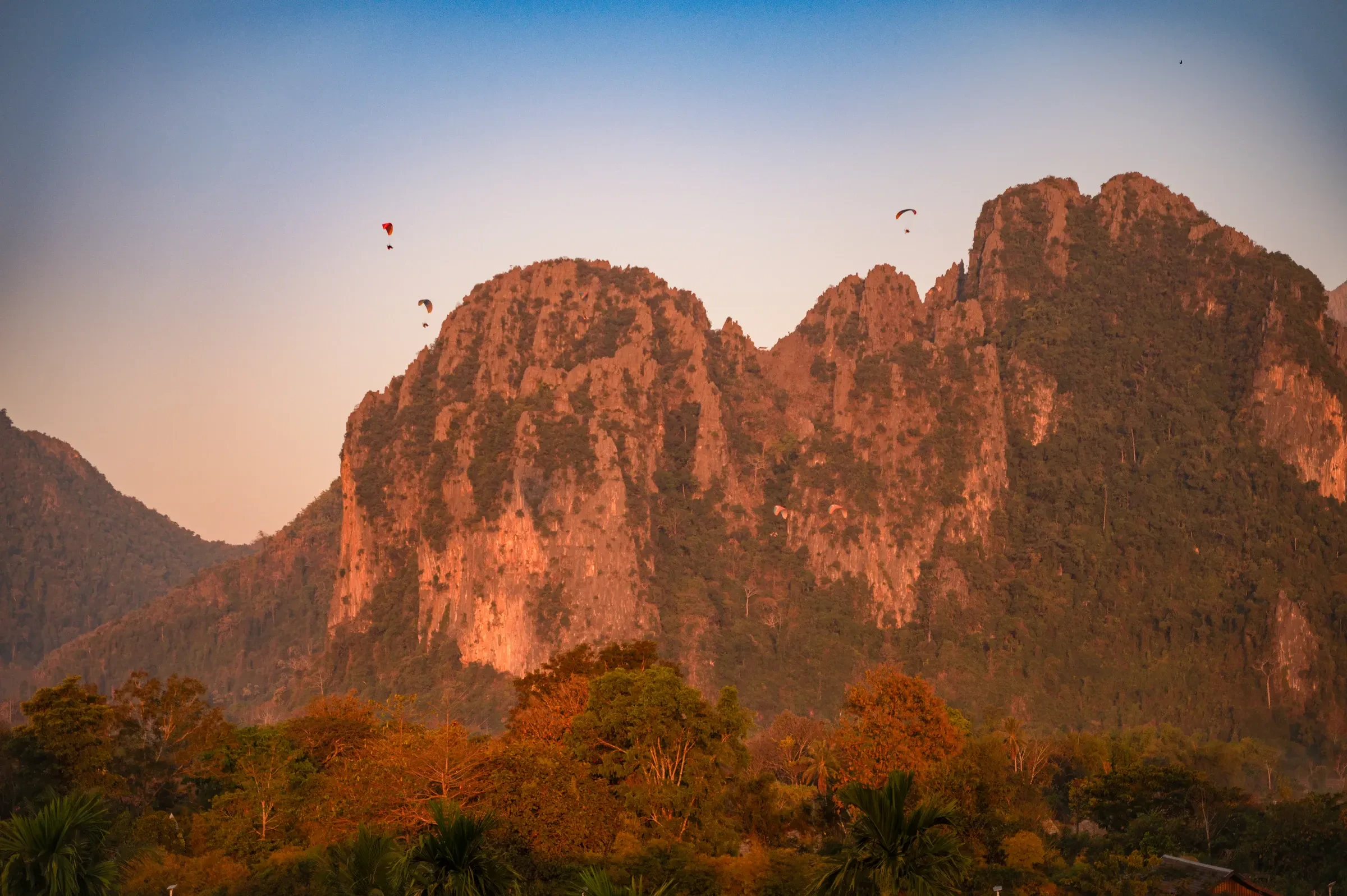 Limestone cliffs above Vang Vieng glowing at sunset