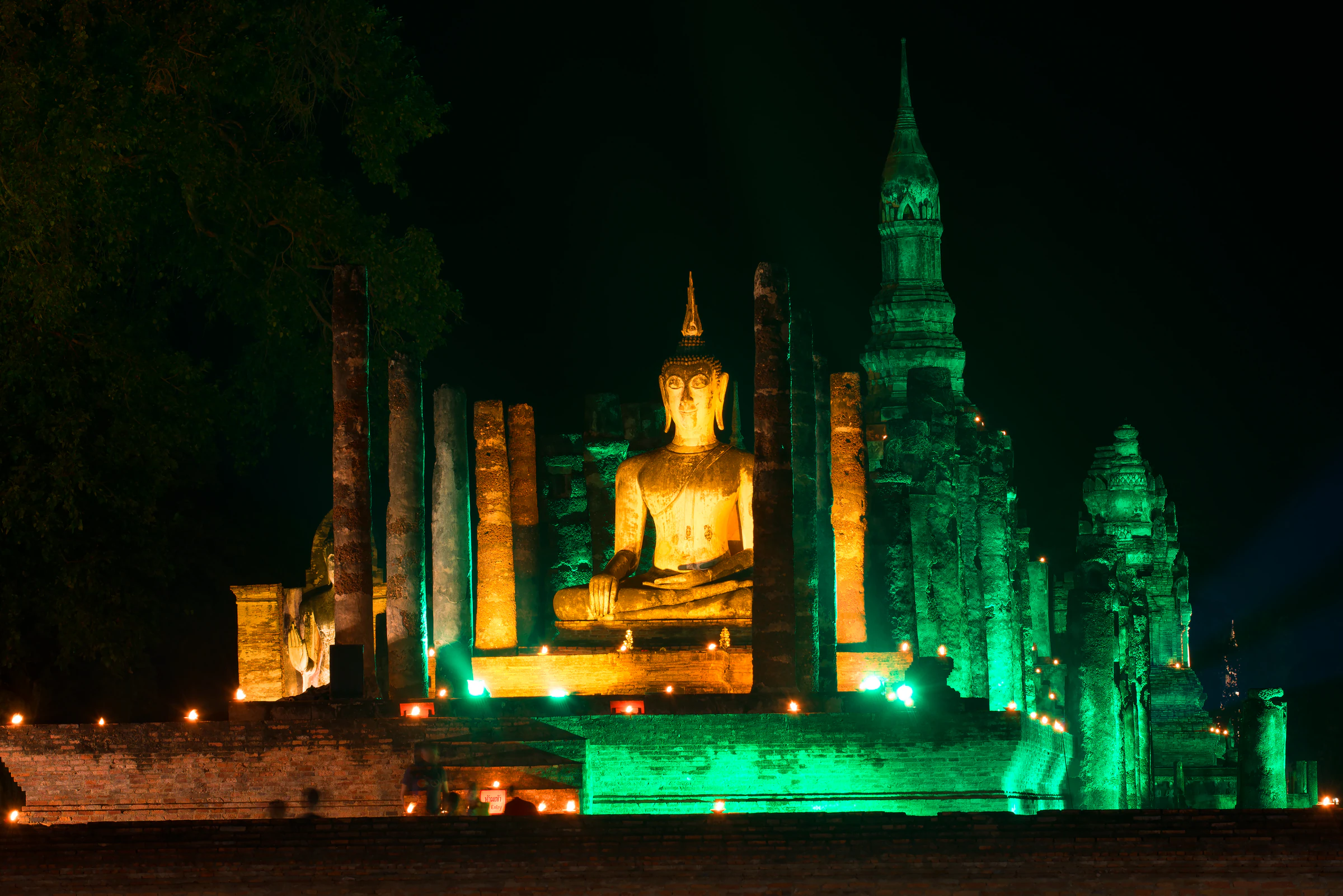 A seated Buddha statue among the ruins of Wat Mahathat, Sukhothai