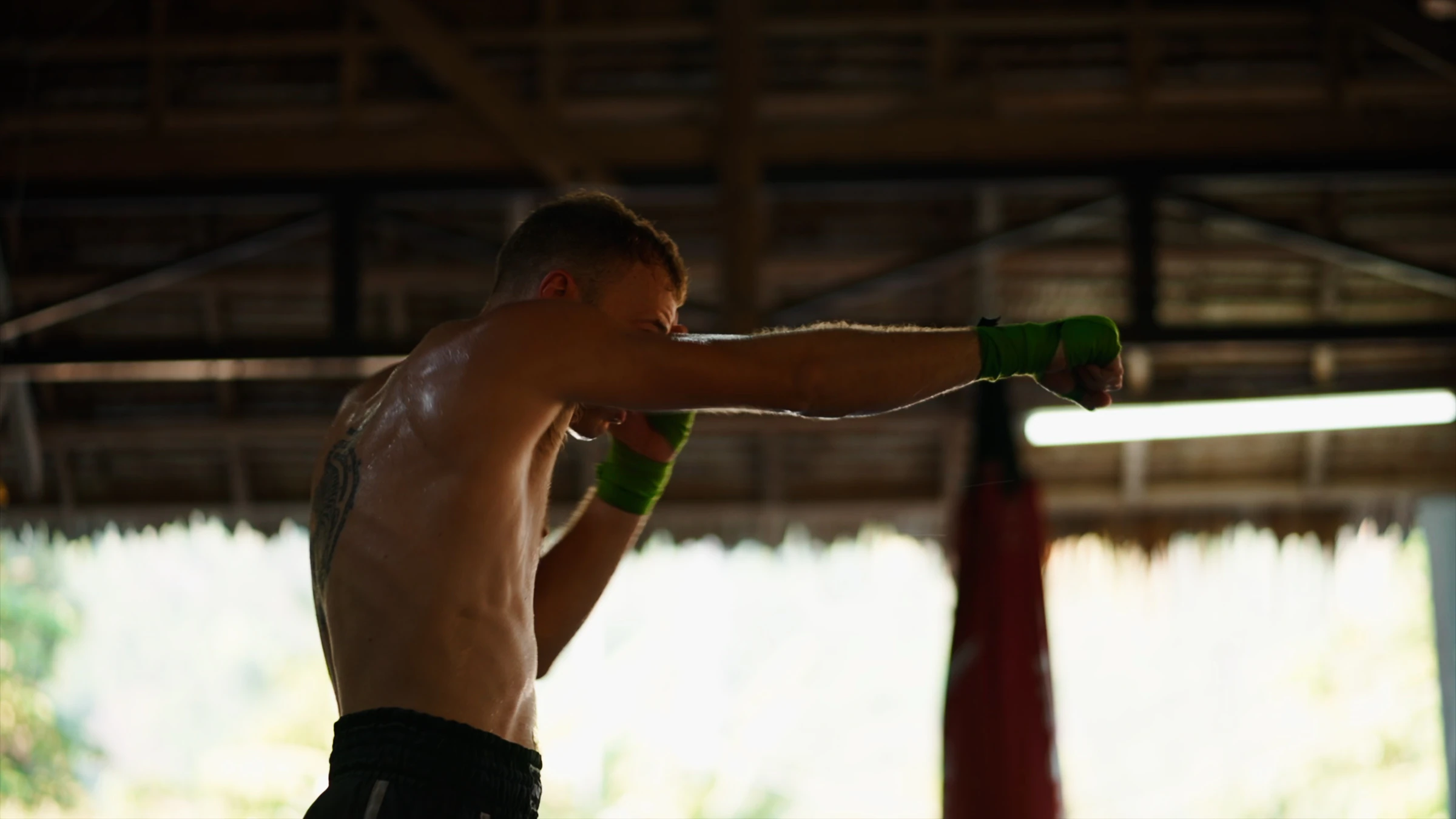 A trainee throwing a straight punch in an open-air gym