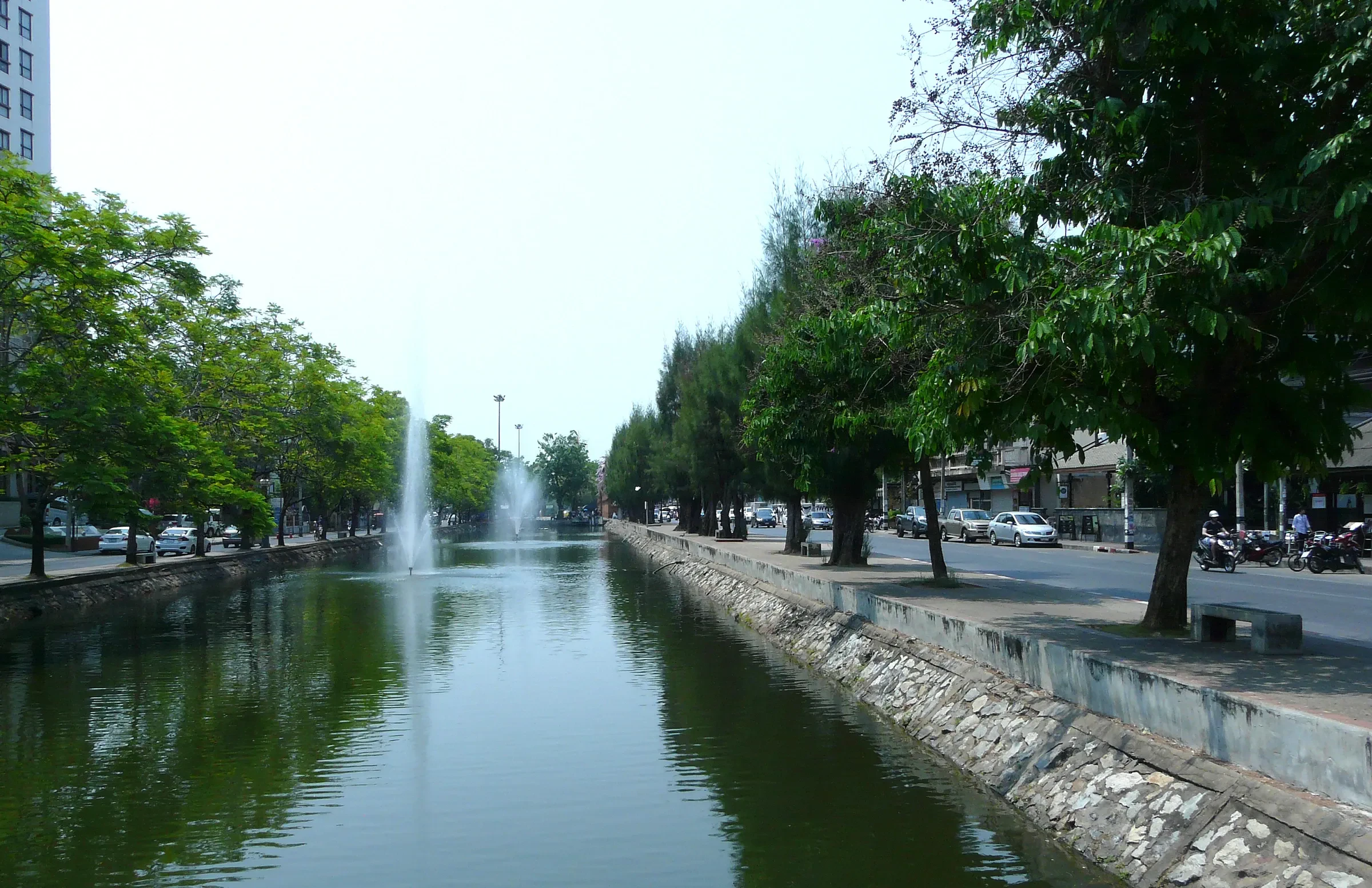 The tree-lined city moat of Chiang Mai's Old City, with a fountain