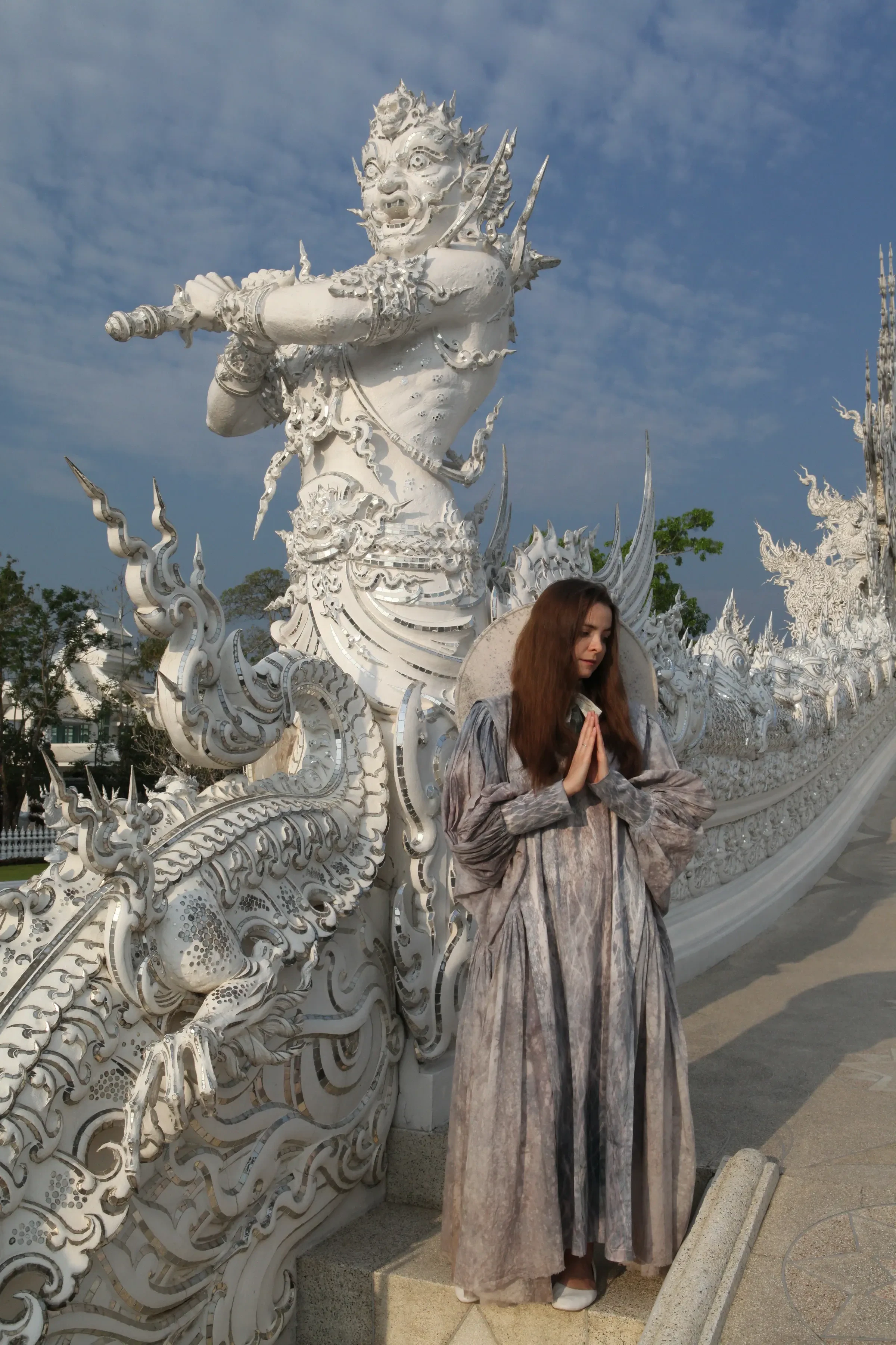 A traveller in front of Wat Rong Khun, the White Temple, in Chiang Rai
