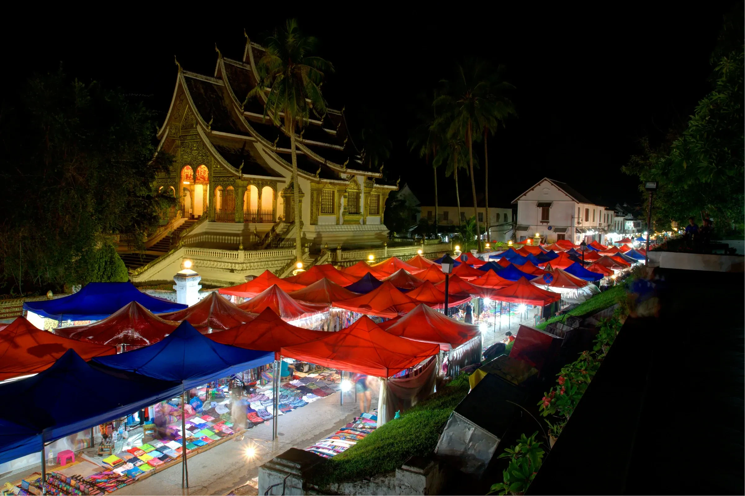 Red-roofed stalls at the Luang Prabang night market after dark