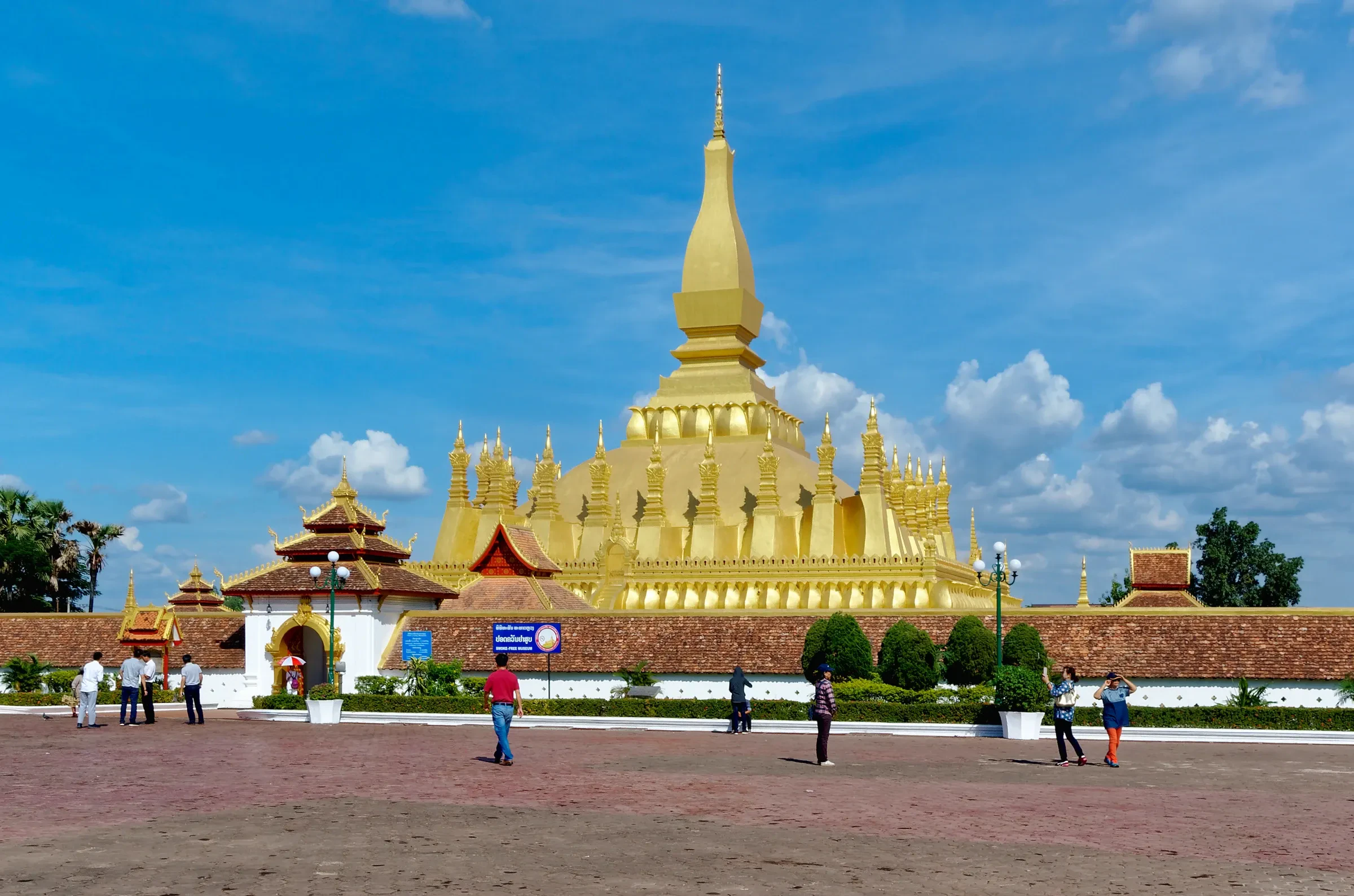 The golden stupa of Pha That Luang in Vientiane under a blue sky