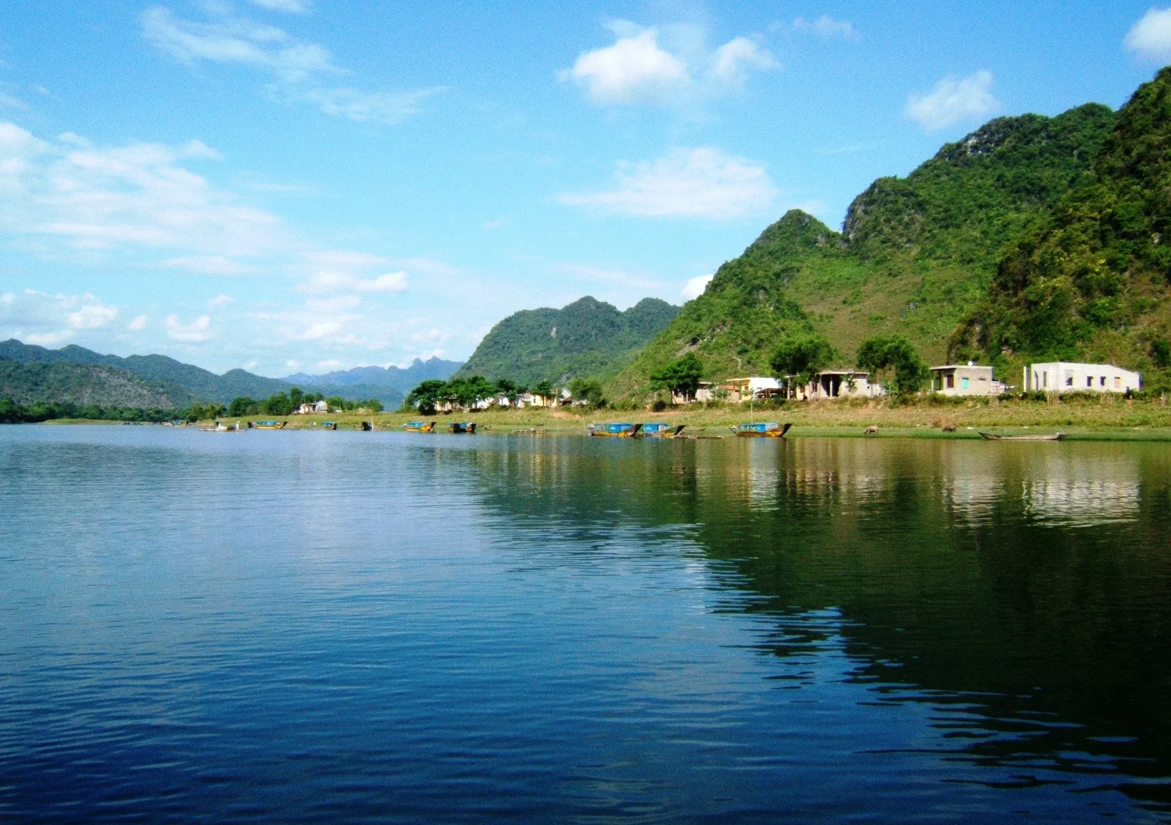 The Son River beneath green limestone hills in Quang Binh province near Phong Nha
