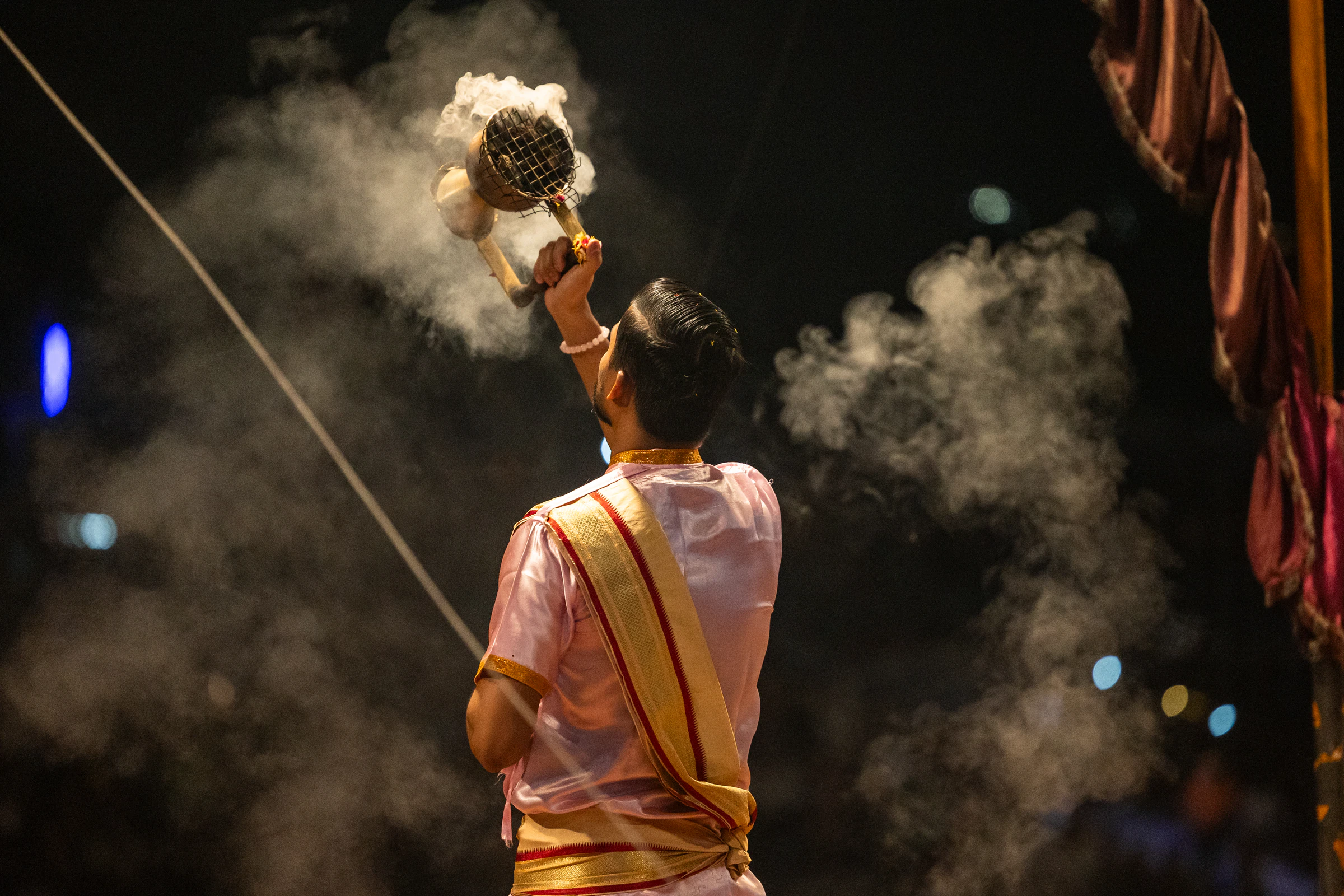 A priest performing the Ganga aarti on the ghats in Varanasi at night