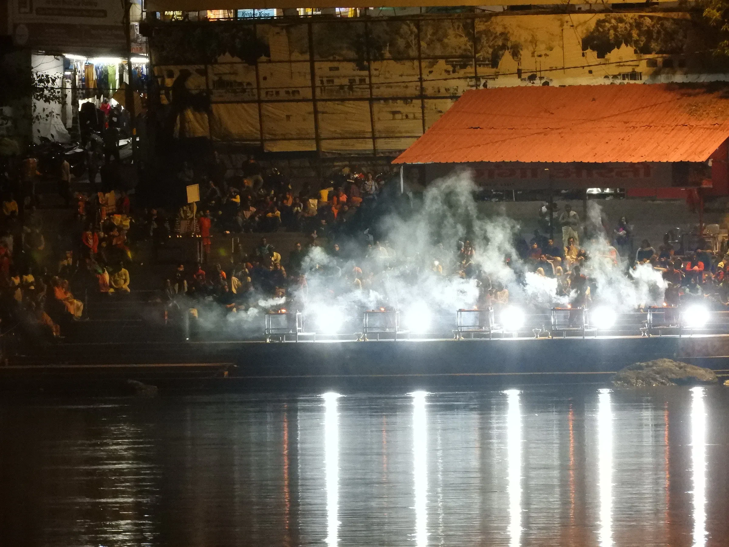 Crowds on the riverbank watching the evening Ganga Aarti in Rishikesh