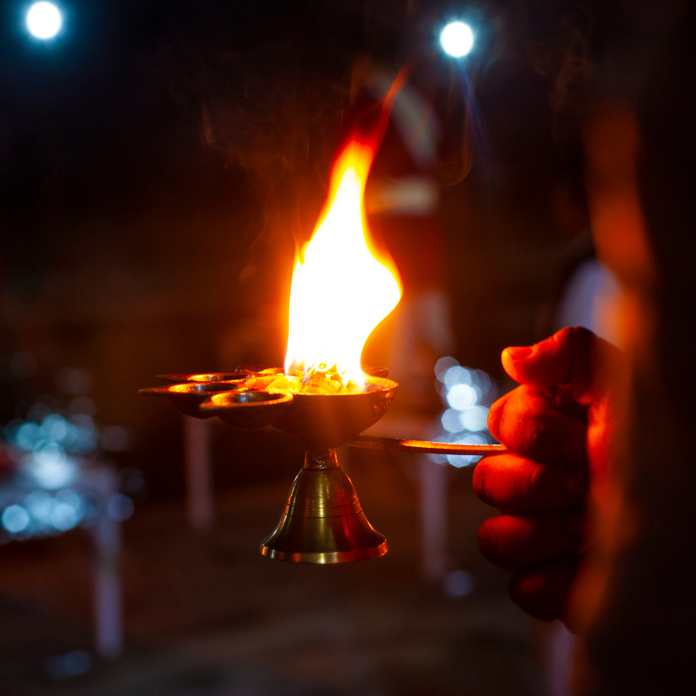 Fire lamps held up during the evening aarti in Rishikesh