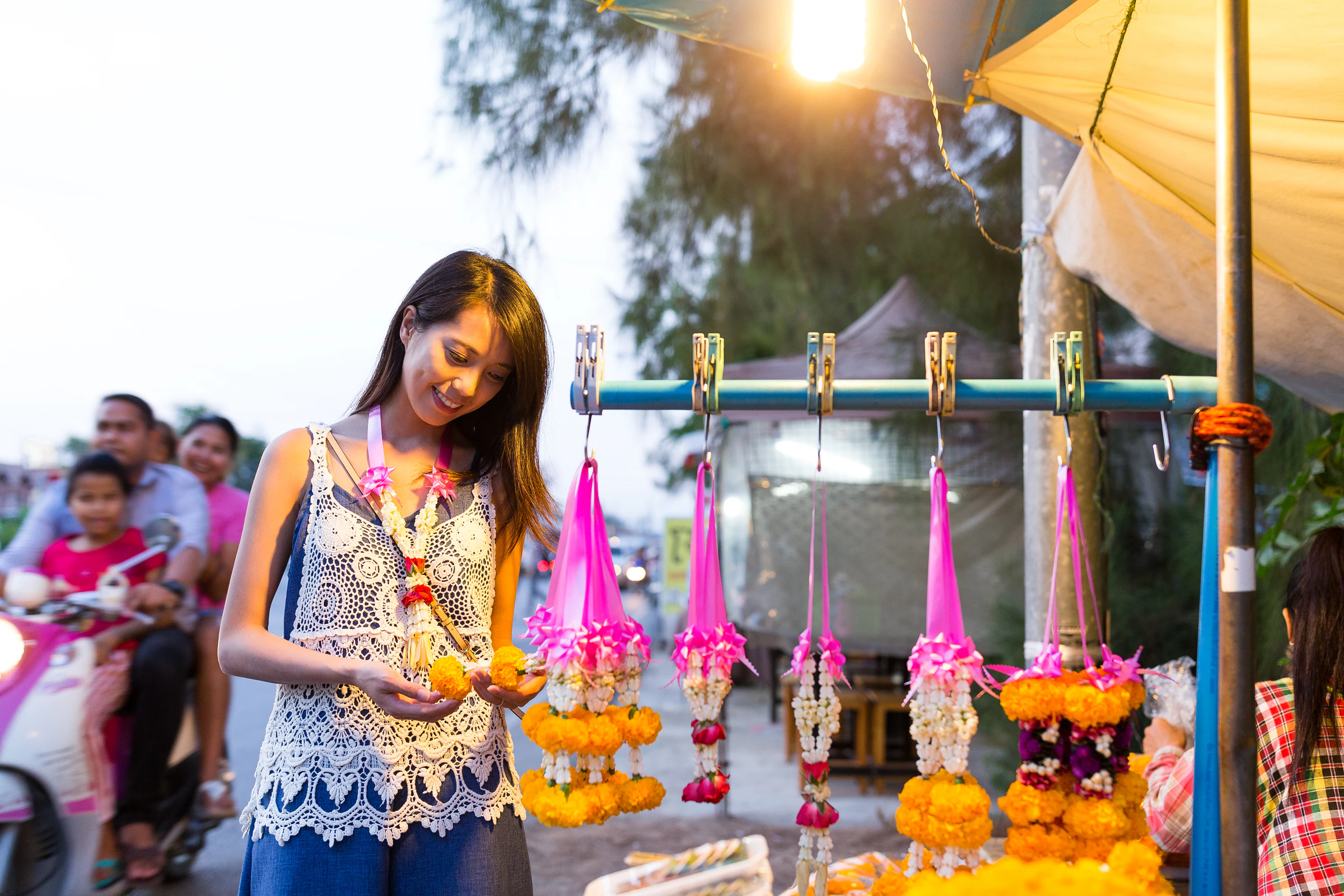 A woman shopping at a street market stall in Thailand
