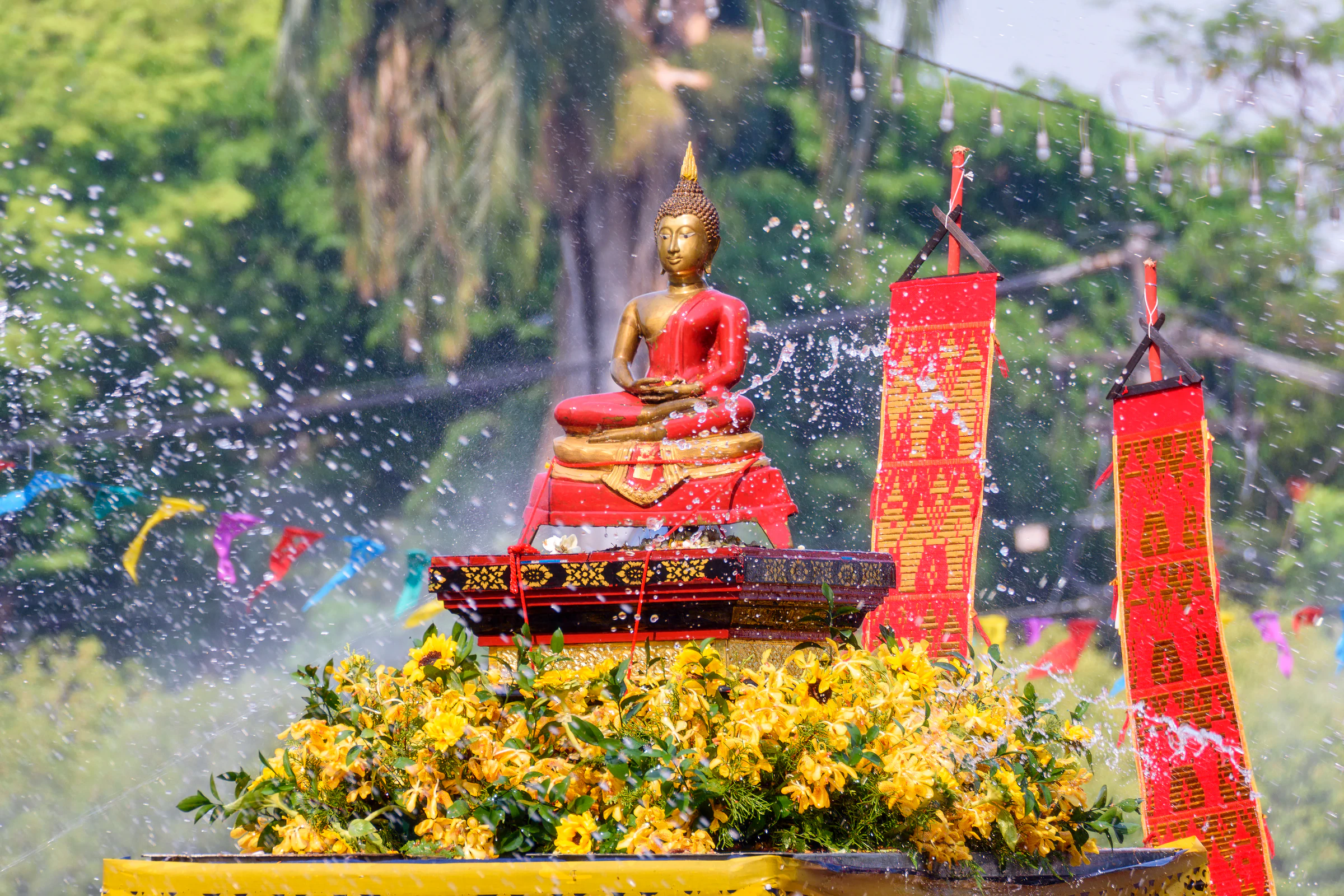Water being poured over a Buddha image at a Chiang Mai temple during Songkran
