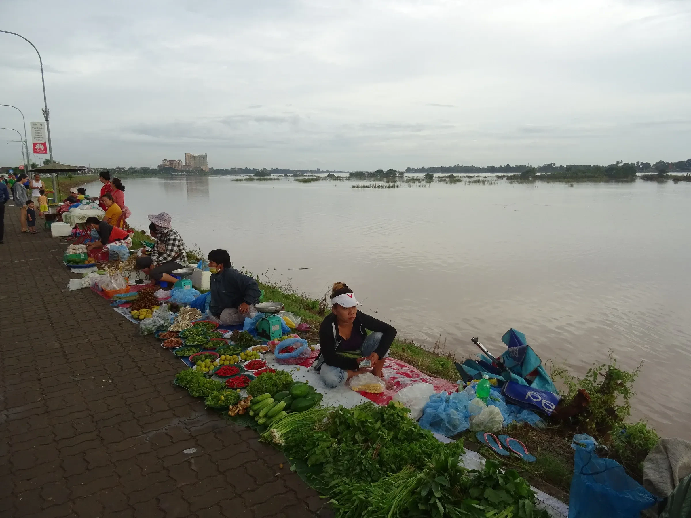 Vendors selling vegetables along the Mekong riverbank in Vientiane