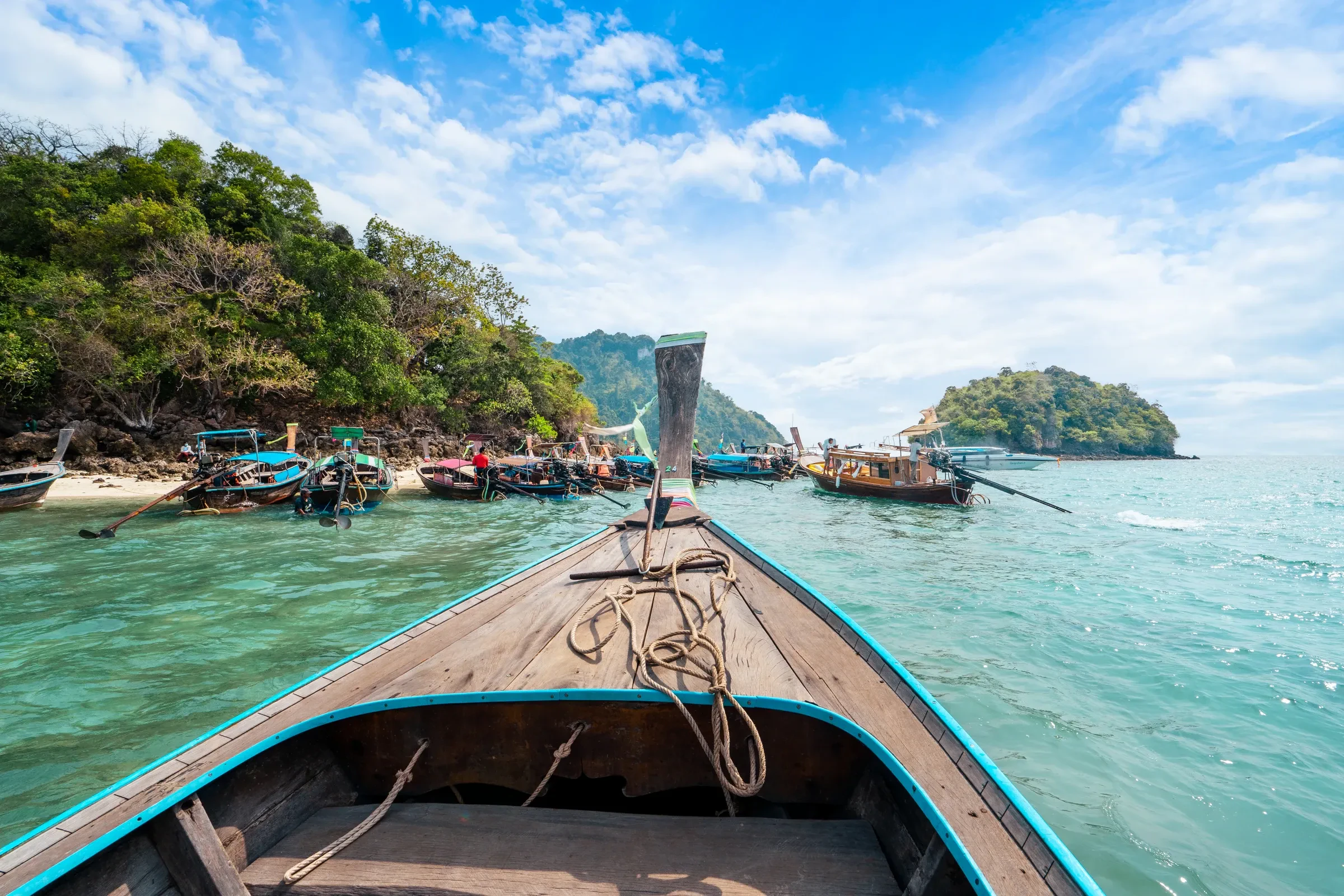 A longtail boat bow heading for green islands off Krabi in the Andaman Sea