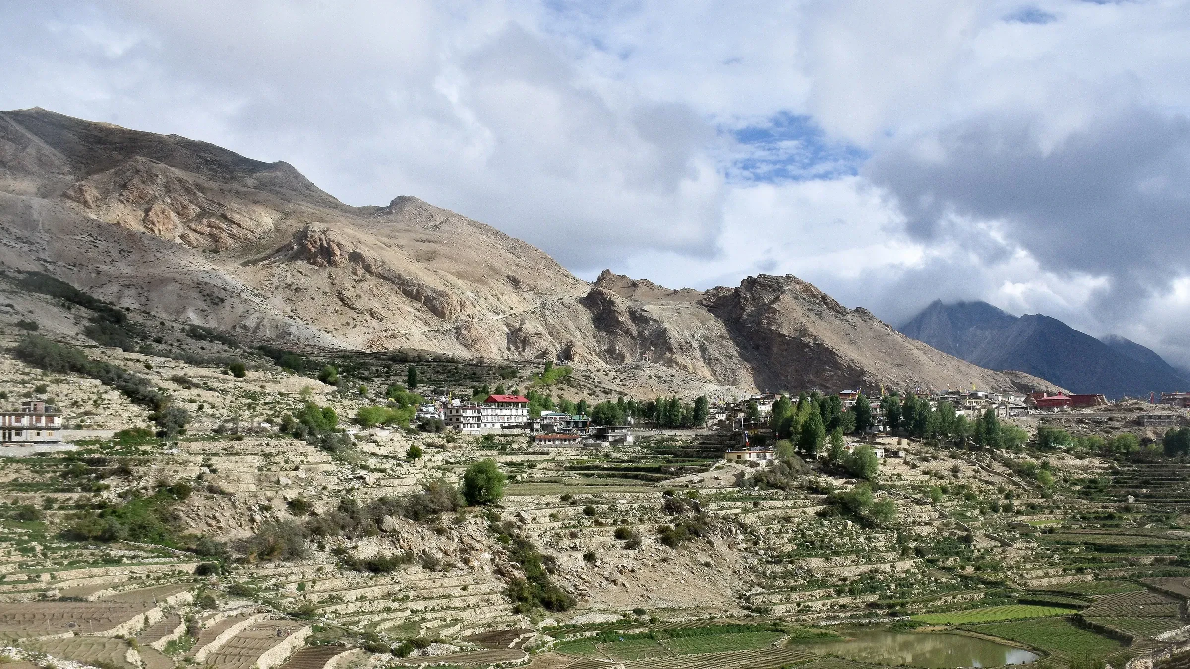 Nako village and its terraced fields below dry mountains in Kinnaur