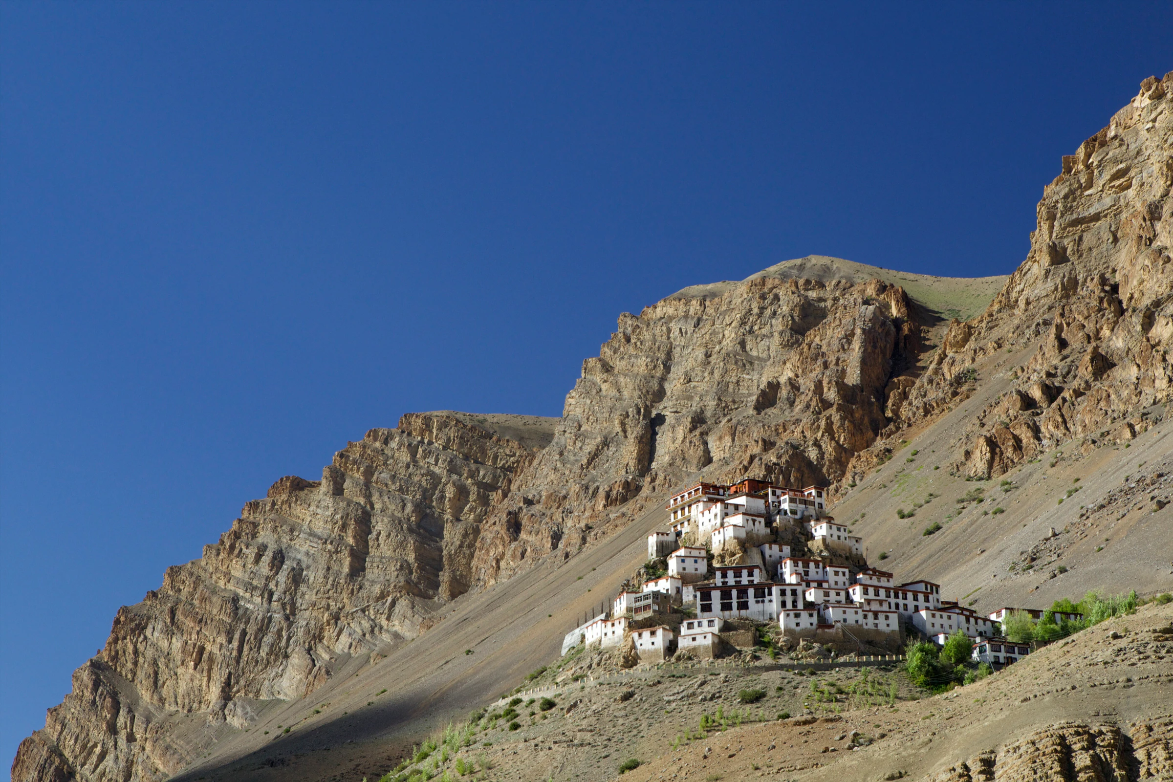 Key Monastery's white buildings stacked on a cone-shaped hill