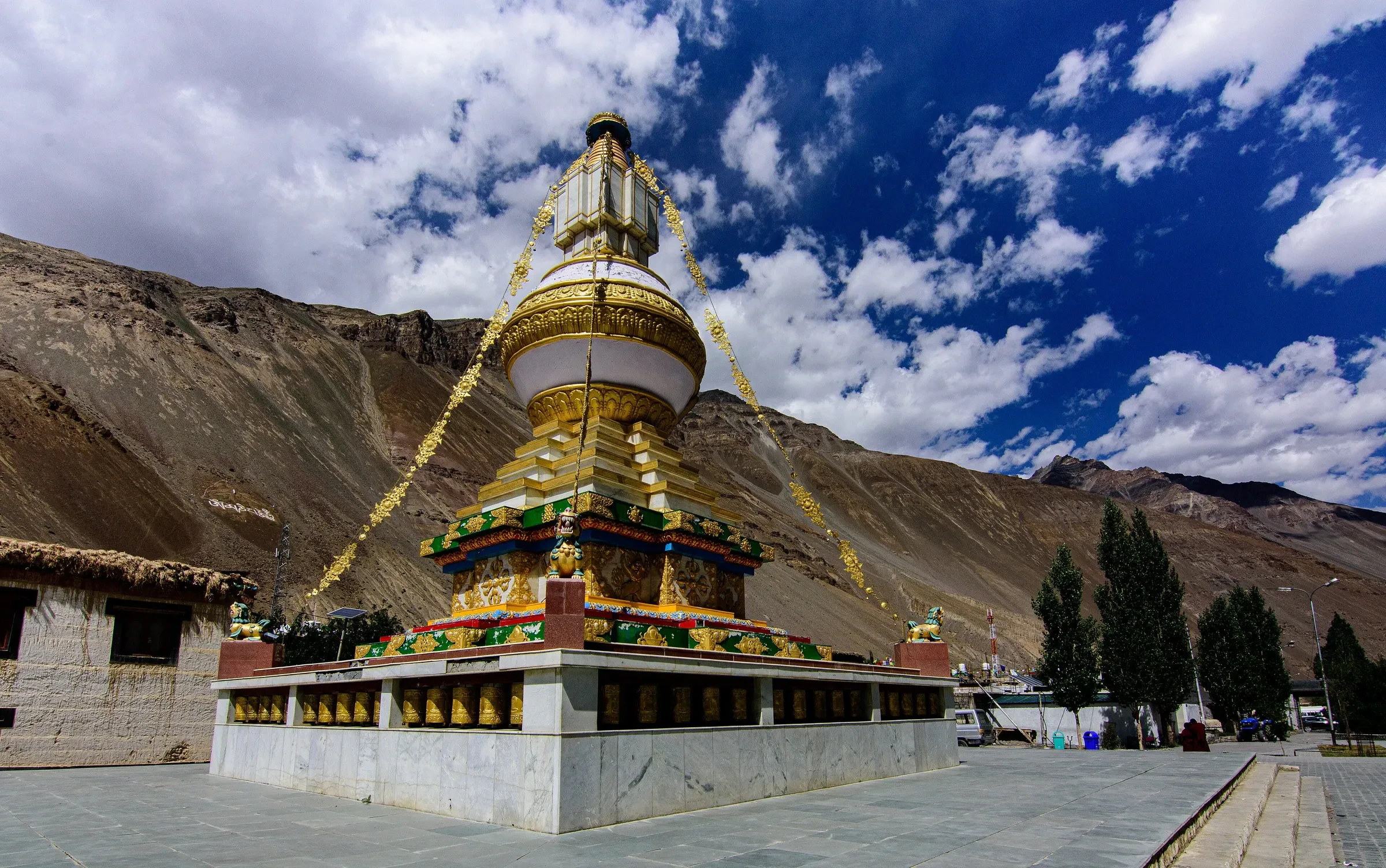 The golden chorten at Tabo Monastery under a cloudy blue sky in Spiti