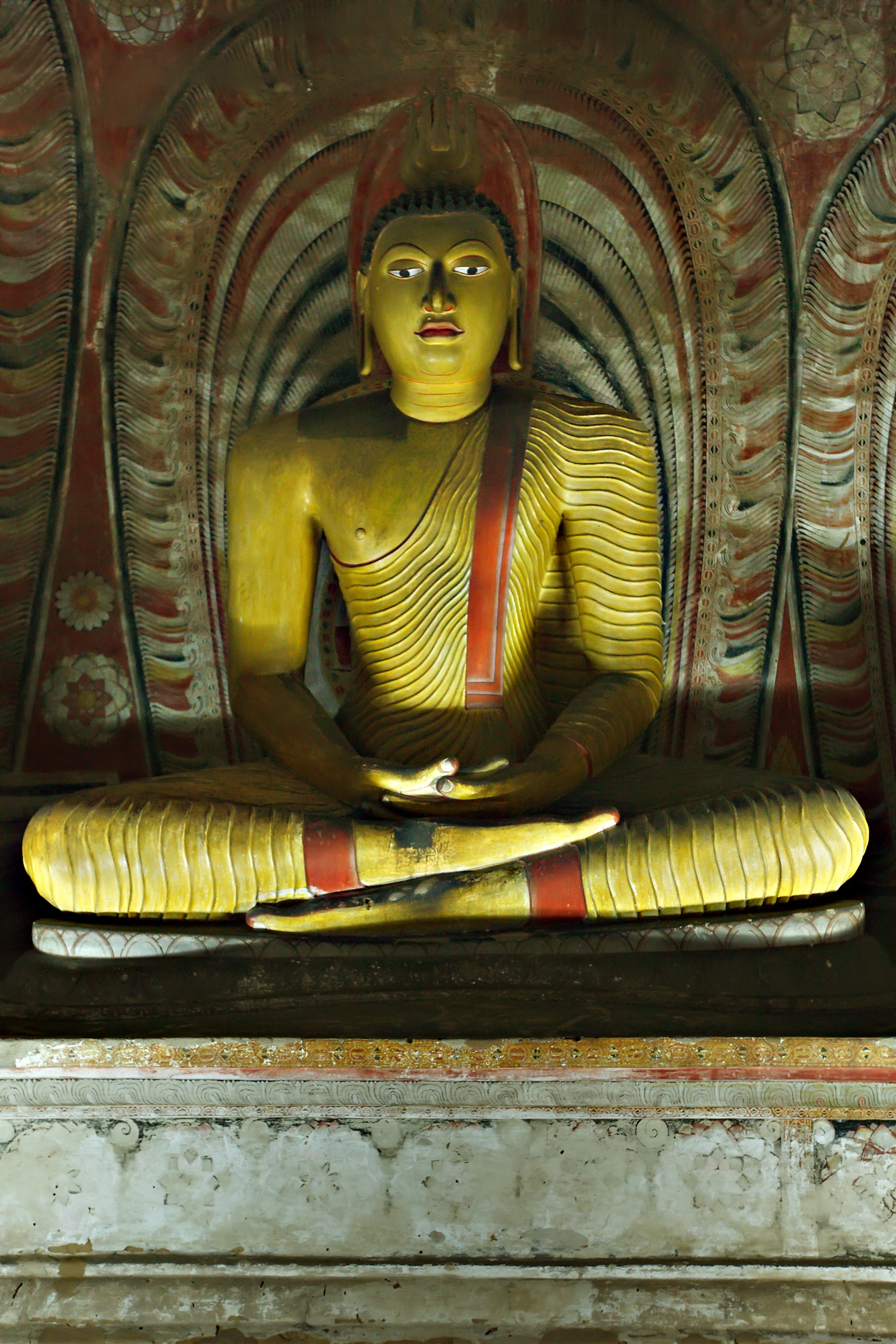A seated Buddha statue inside a Dambulla cave temple