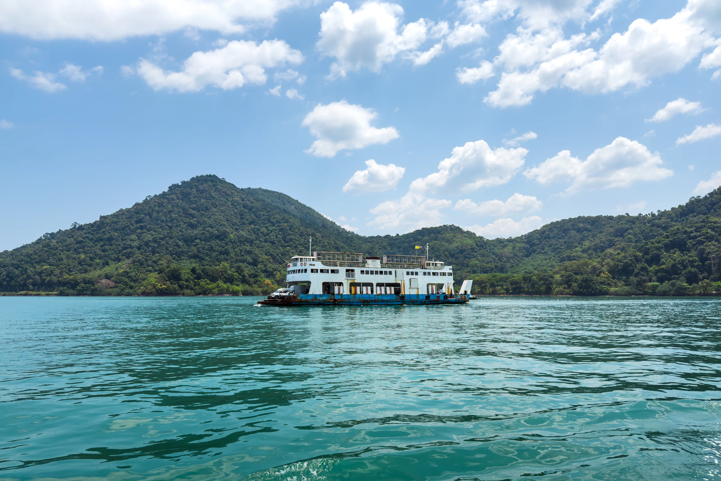 An island ferry crossing calm turquoise water