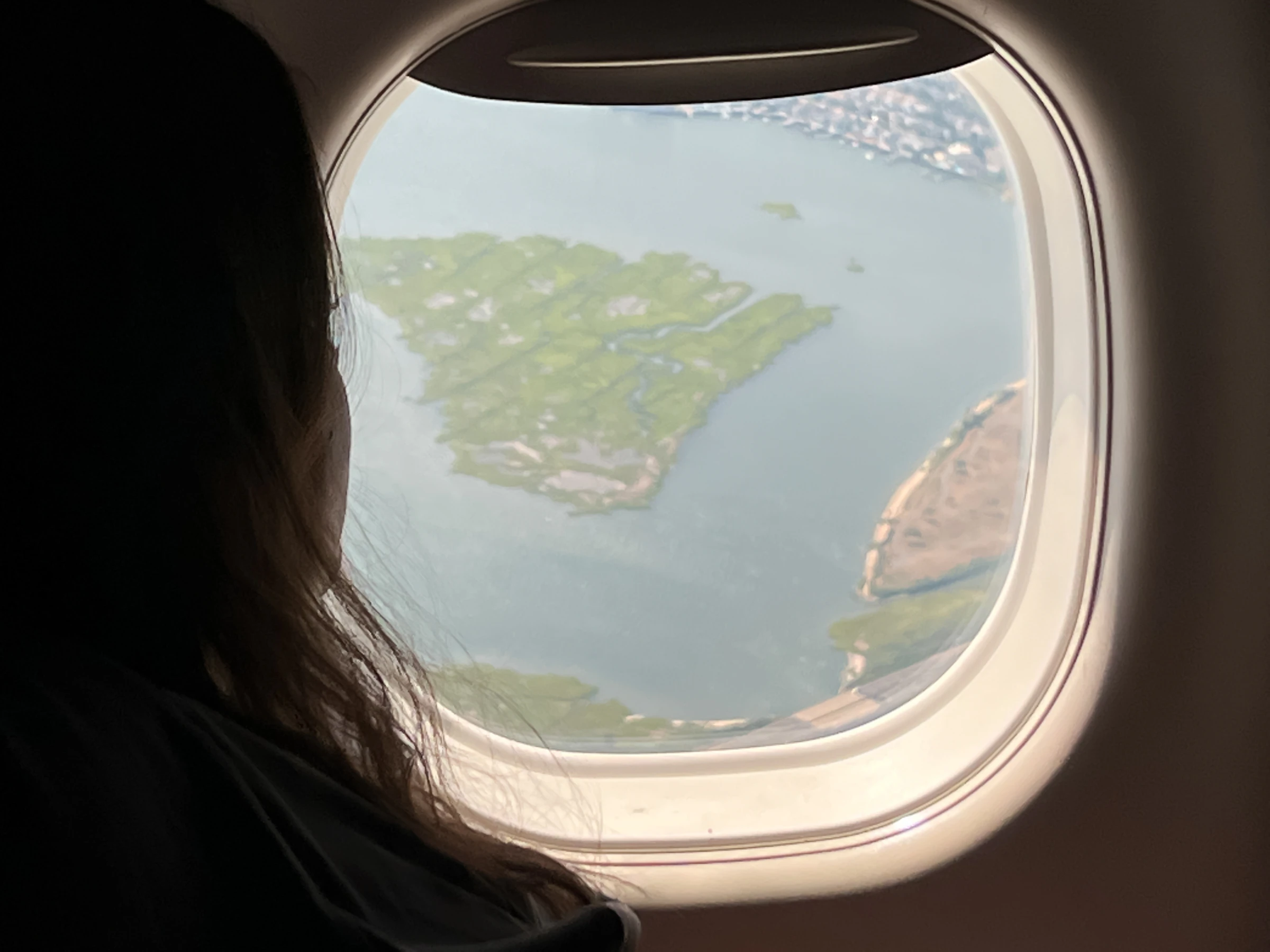 A traveller looking out of a plane window on arrival