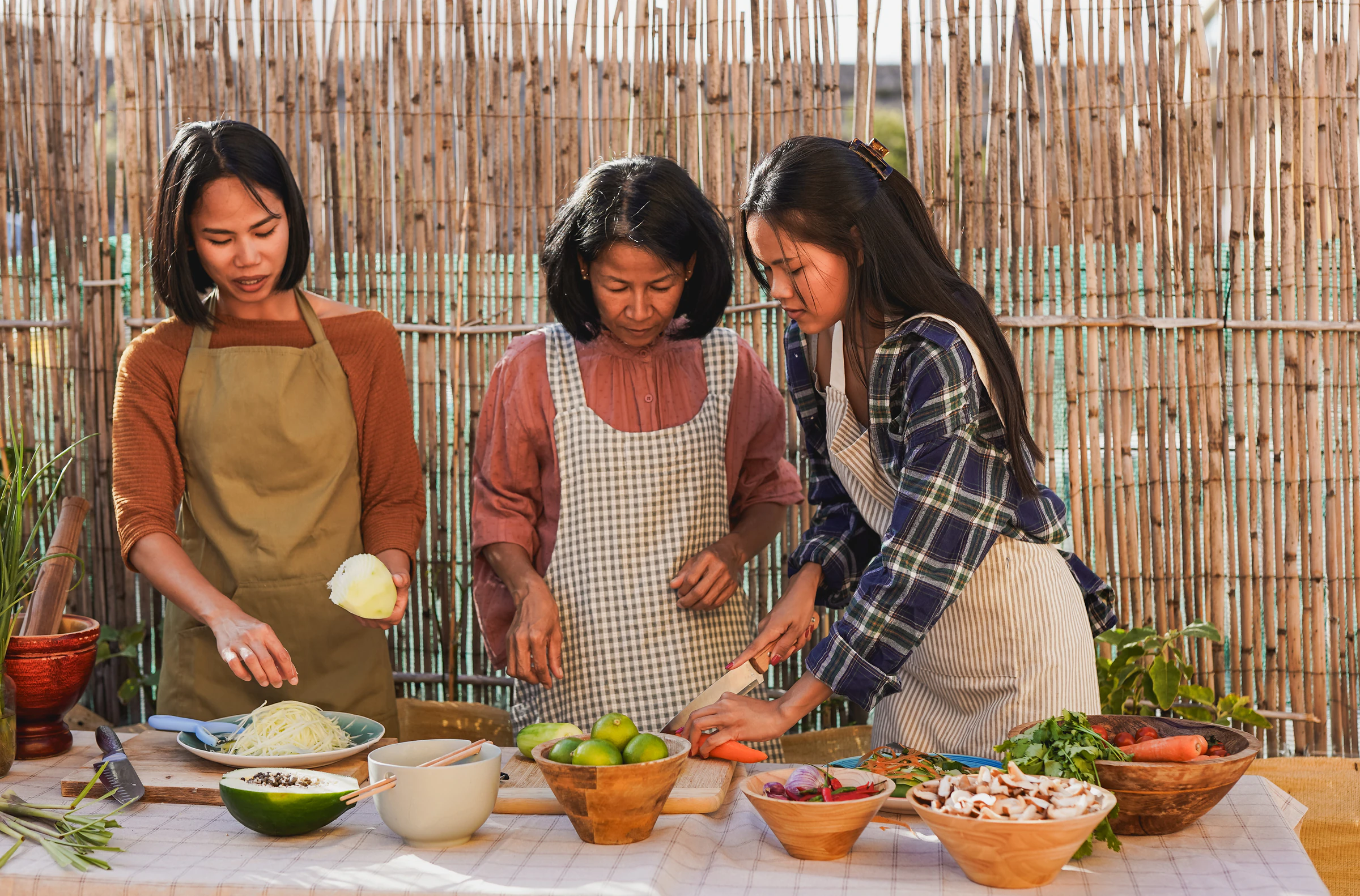 Preparing ingredients for a Thai cooking class at an outdoor table