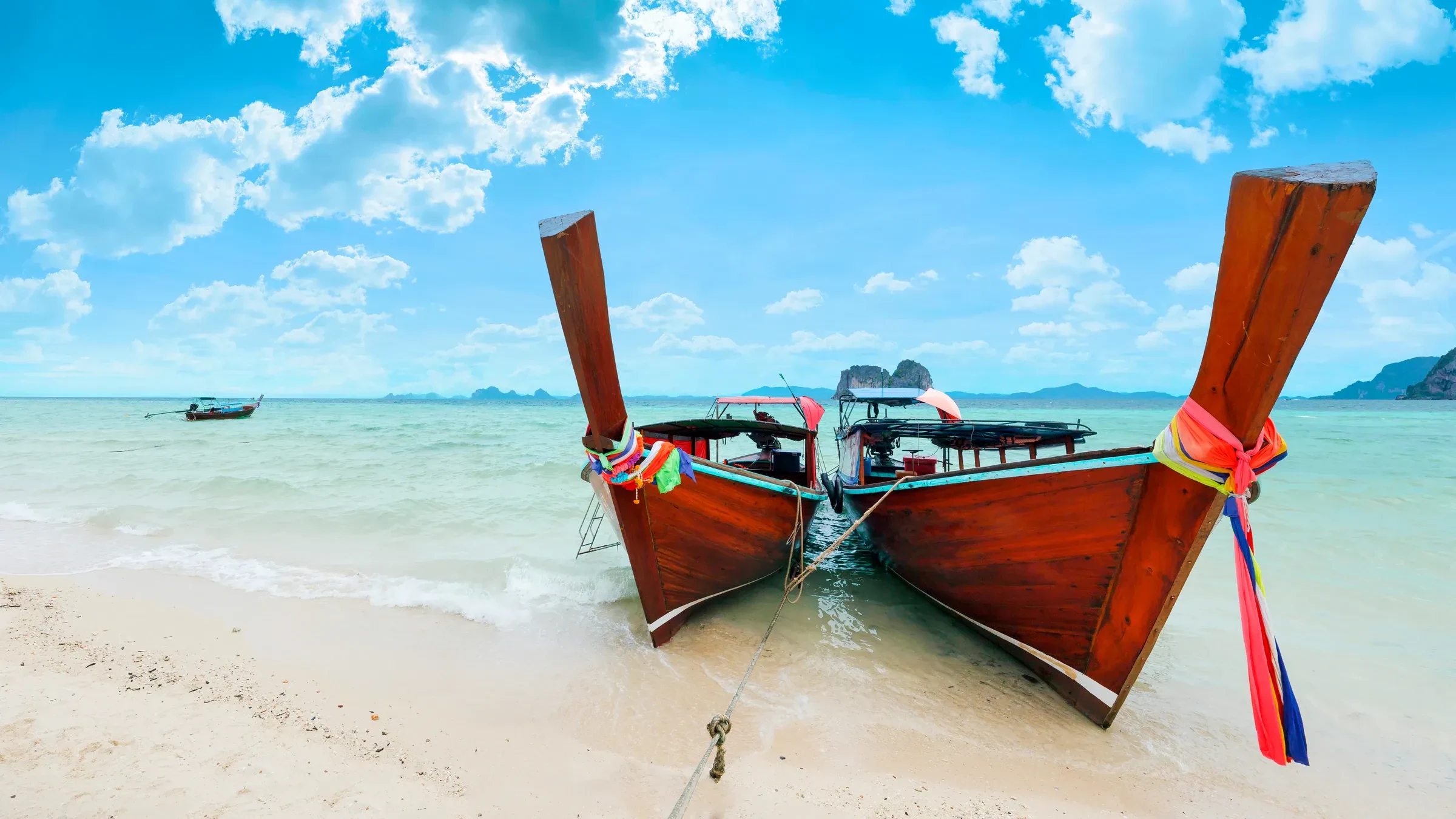 A longtail boat pulled up on the sand at Koh Ngai, near Koh Lanta