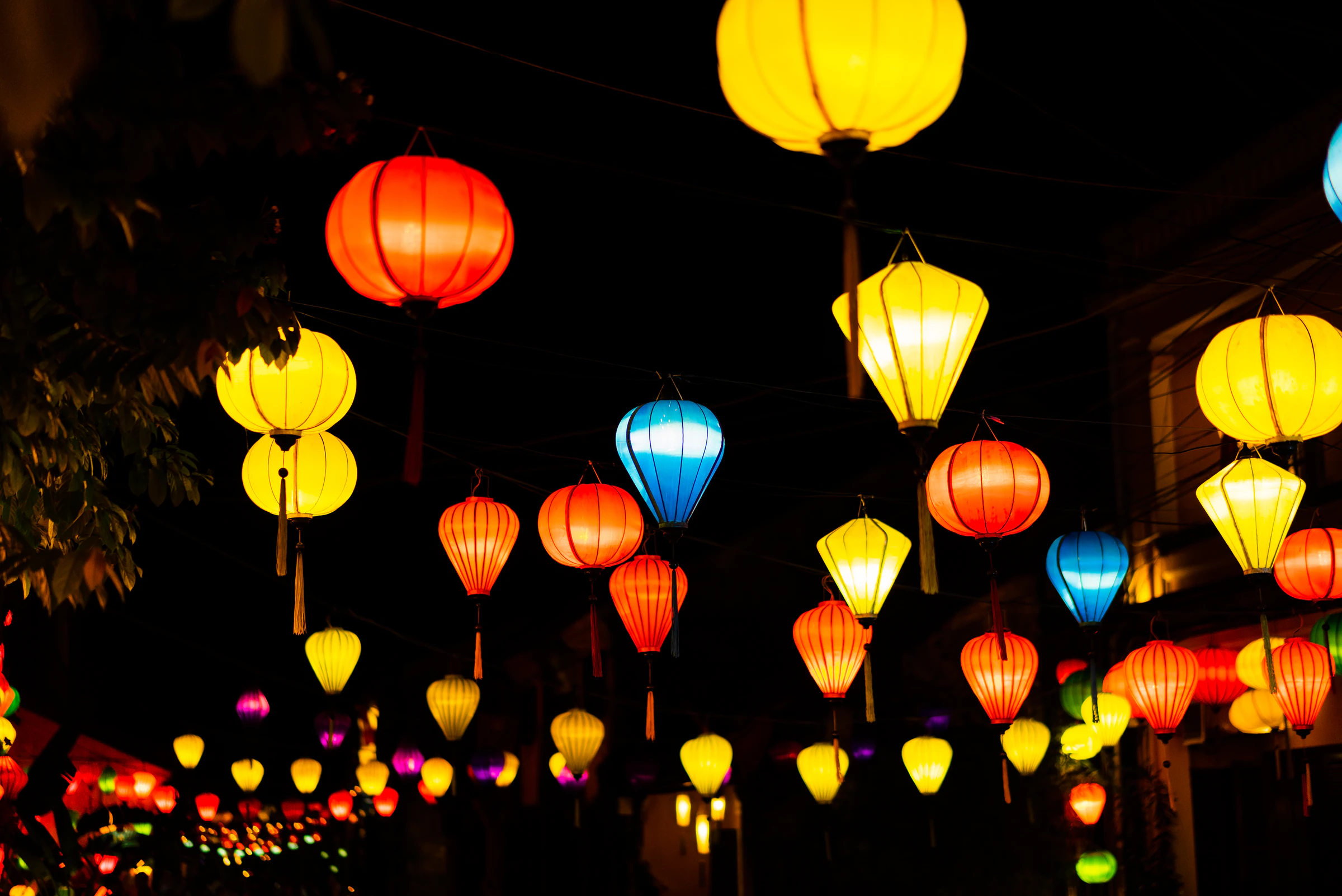 Traditional lanterns strung above a street in Hoi An's old town