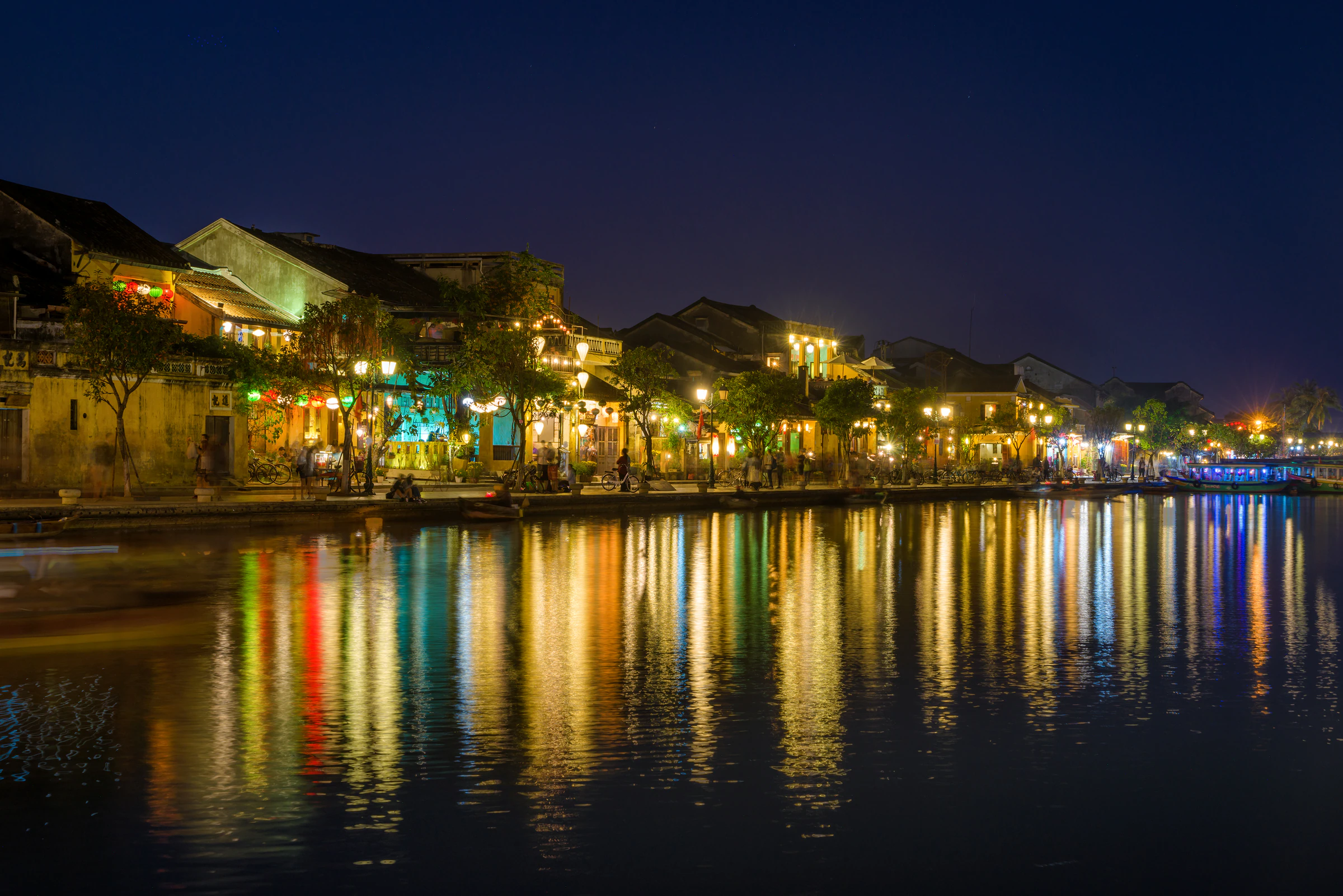Hoi An old town lit by lanterns and reflected in the river at night